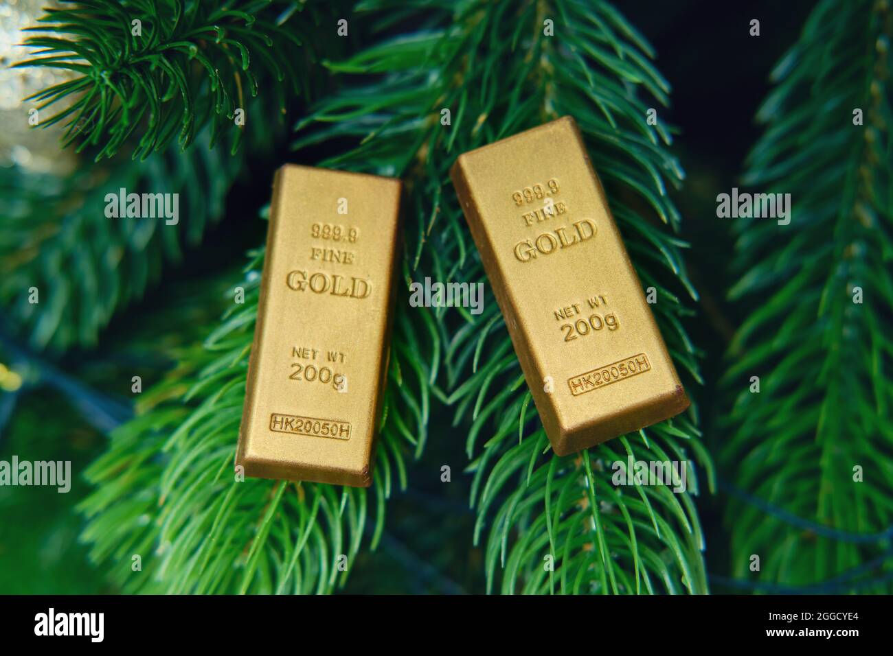 Gold bars on the branch of the Christmas tree on New Year Eve Stock Photo