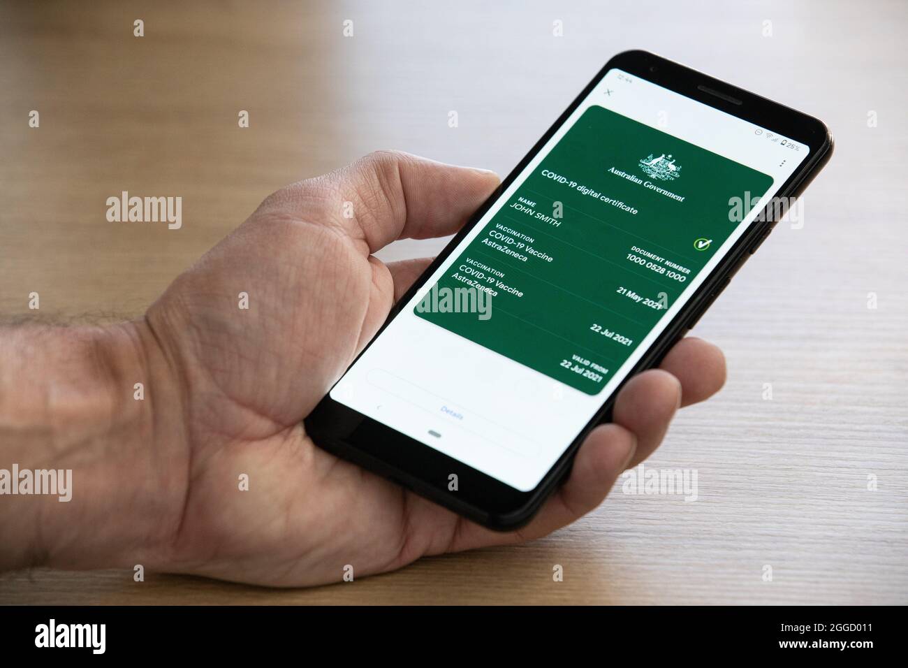 The Australian digital Covid-19 Vaccination certificate as displayed on a phone.  (The name and number has been changed on this image) Stock Photo