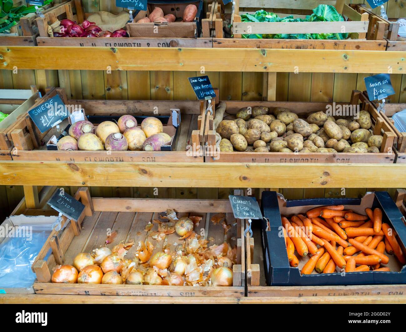 An attractive display of fruit and vegetables with 2021 price tickets in a farm shop in North Yorkshire Stock Photo
