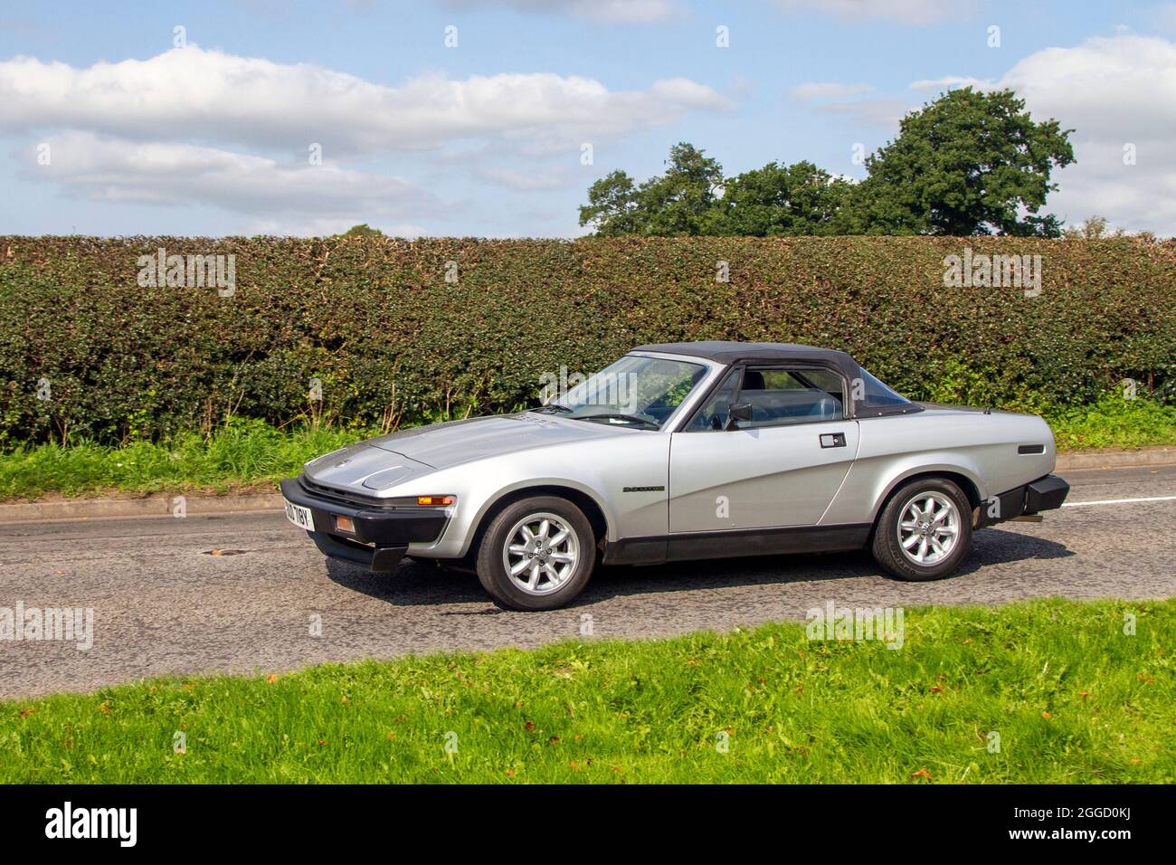 1982 80s silver Triumph TR7 1998cc petrol two seater, 2dr British sports car en-route to Capesthorne Hall classic August car show, Cheshire, UK Stock Photo