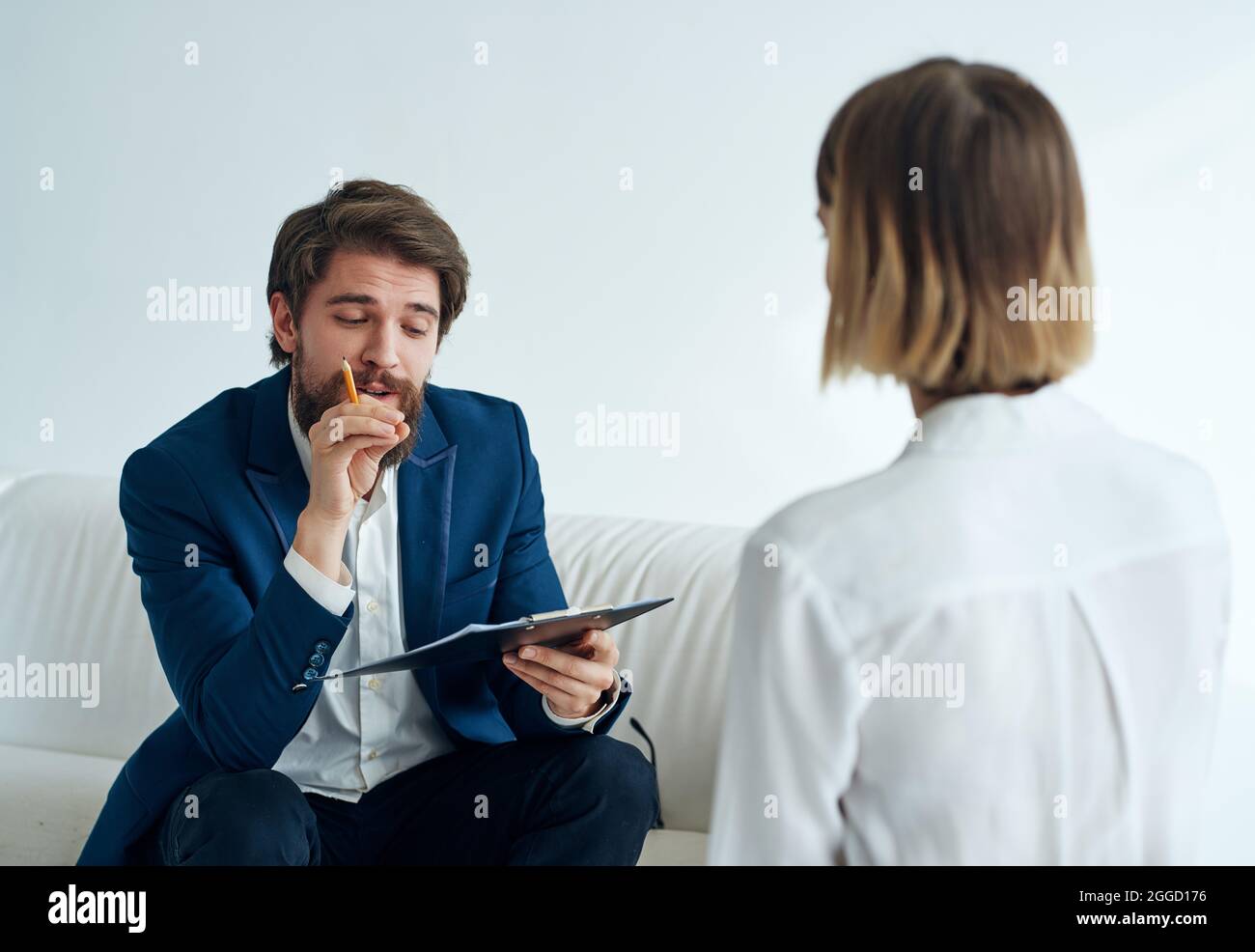 a man communicates with a woman patient a visit to a psychologist