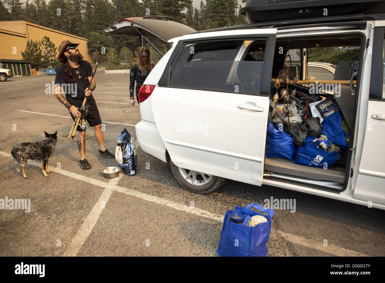 Echo Lake, United States. 31st Aug, 2021. Brandon Barkdoll rearranges his belongings with his wife Karissa and dog Rory at Harrah's Lake Tahoe after evacuating from their home the Caldor fire near Echo Lake, California on Monday, August 30, 2021. The city of South Lake Tahoe is under evacuation orders. Photo by Peter DaSilva/UPI Credit: UPI/Alamy Live News Stock Photo