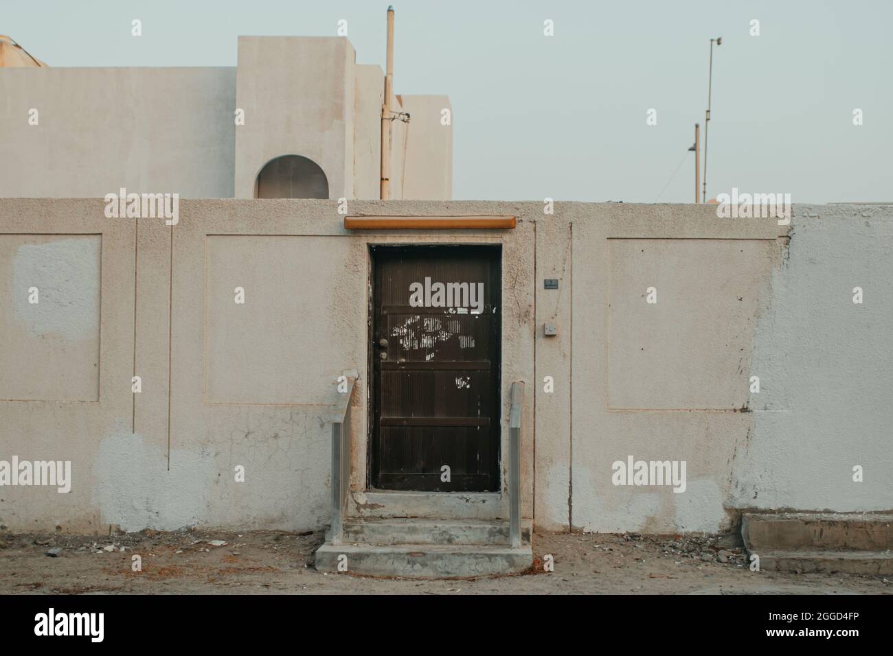 Empty Entrance to the Old Retro House Building with Brown Door in Front of Street Stock Photo