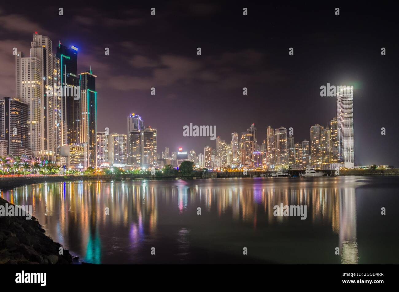 Night Time View of Panama City Seafront with Reflections in the Ocean Stock Photo