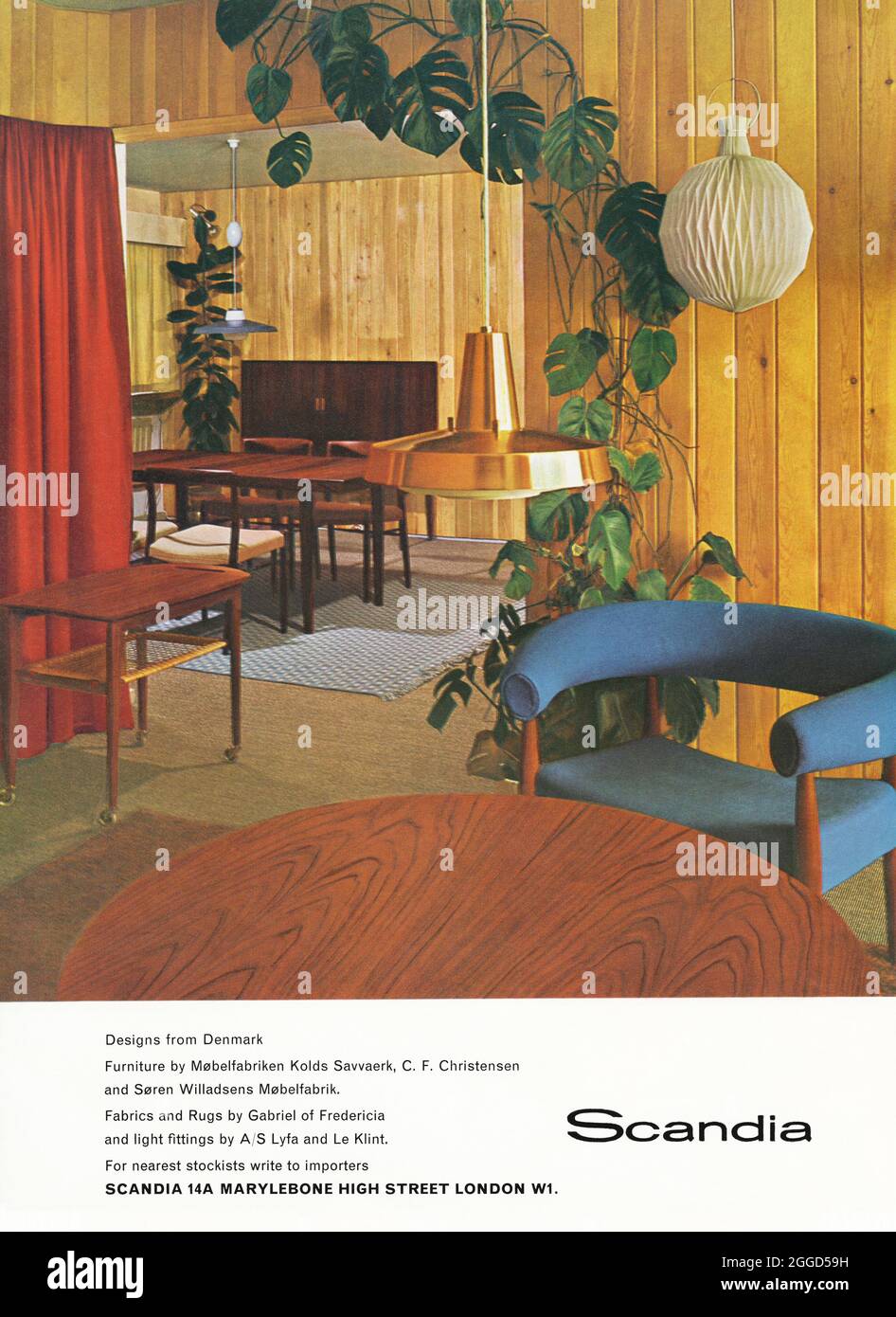 A 1960s advert for stylish, mid-century home furnishings made in Denmark – on display at the Scandia showroom, Marylebone High Street, London, England, UK. The advert appeared in a magazine published in the UK in October 1962. The photograph features furniture, lighting, rugs and carpets by leading Danish designers and producers such as Kolds Savvaerk, C F Christensen, Møbelfabrik and Le Klint – vintage 1960s graphics. Stock Photo