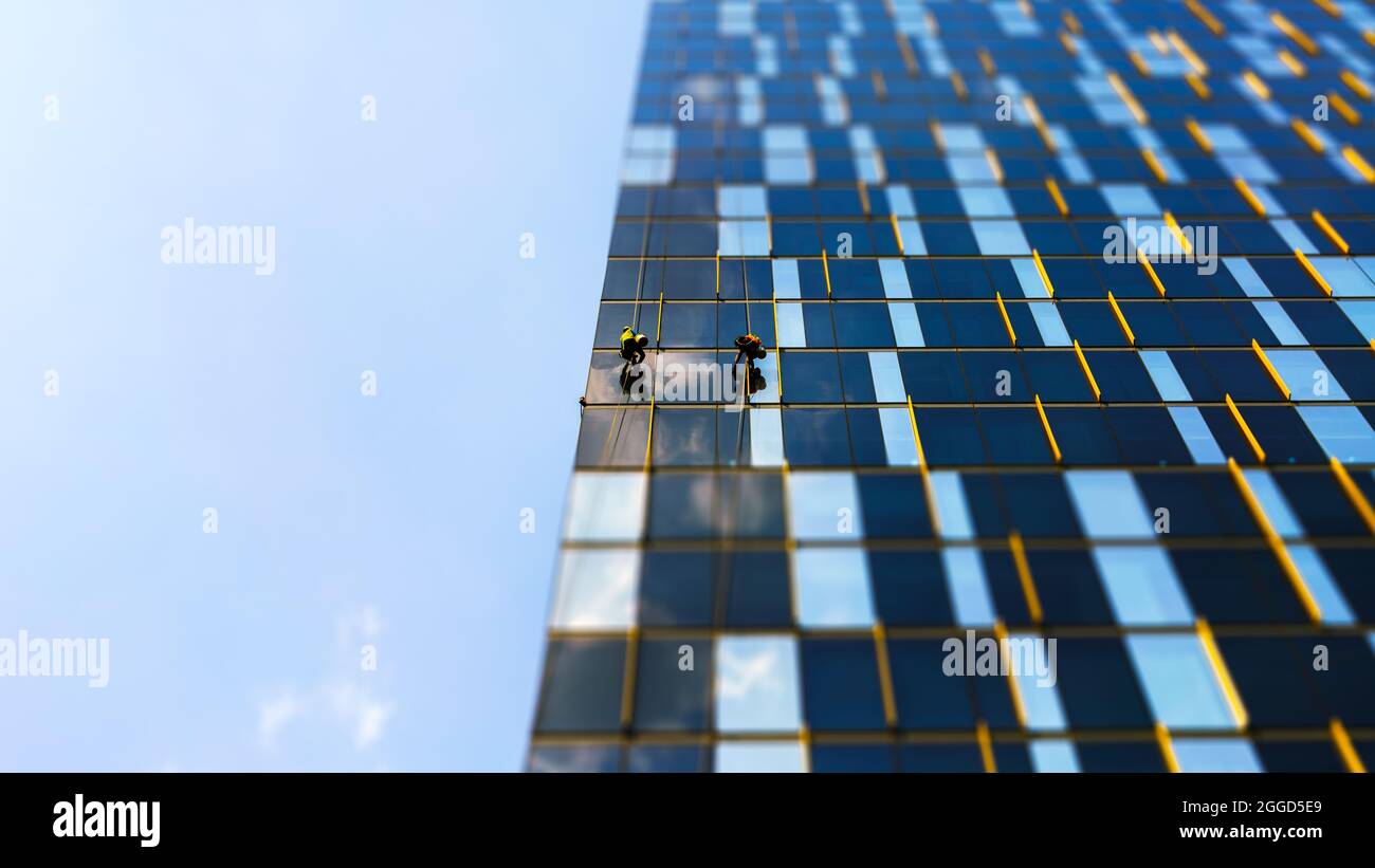 Glass cleaners work very professionally on the building Stock Photo Alamy