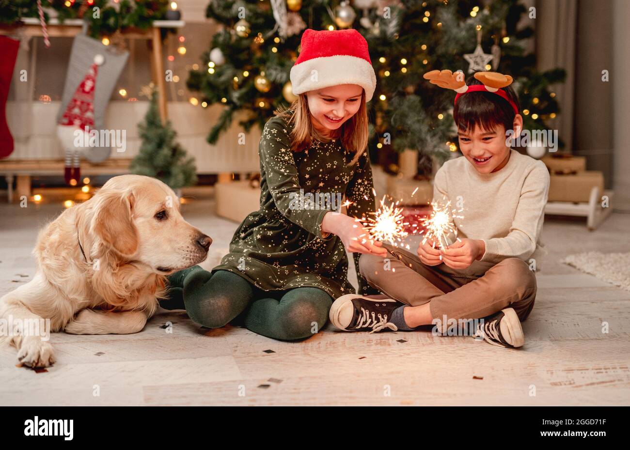 Little girl and boy holding sparklers Stock Photo