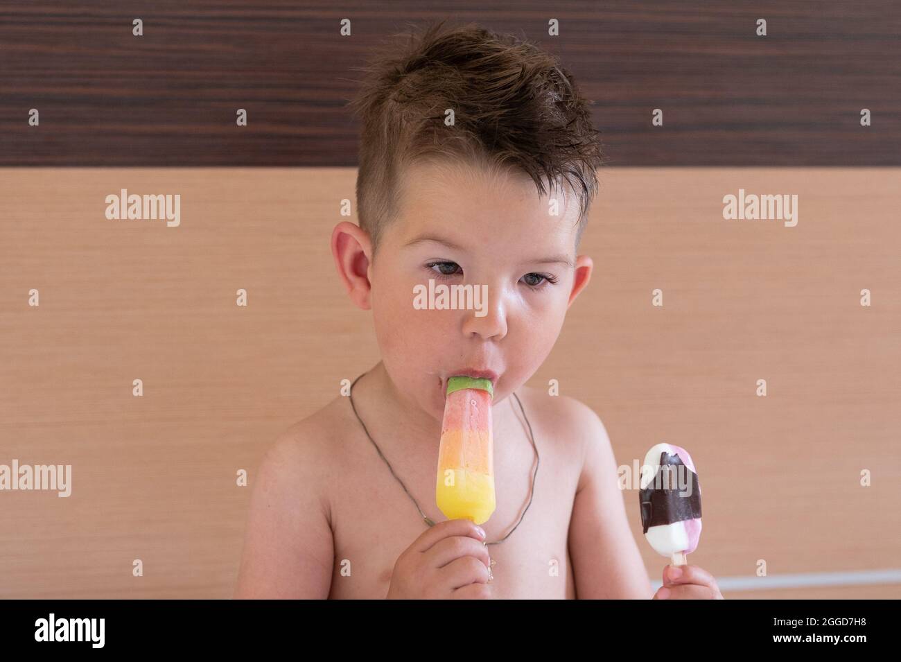 The child eats two ice creams Stock Photo Alamy