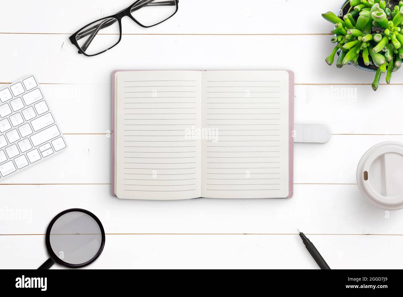 Clean notebook on work desk. Creative flat lay composition on white wooden desk Stock Photo