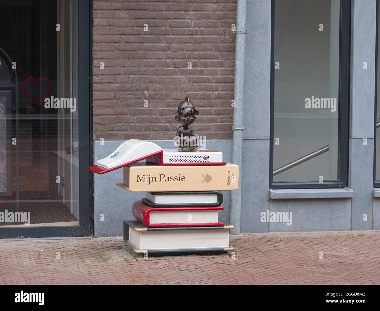 Hulst, Netherlands, August 29, 2021, Large giant books marked My passion and a helmeted doll reading at the library of the municipality of Hulst in th Stock Photo