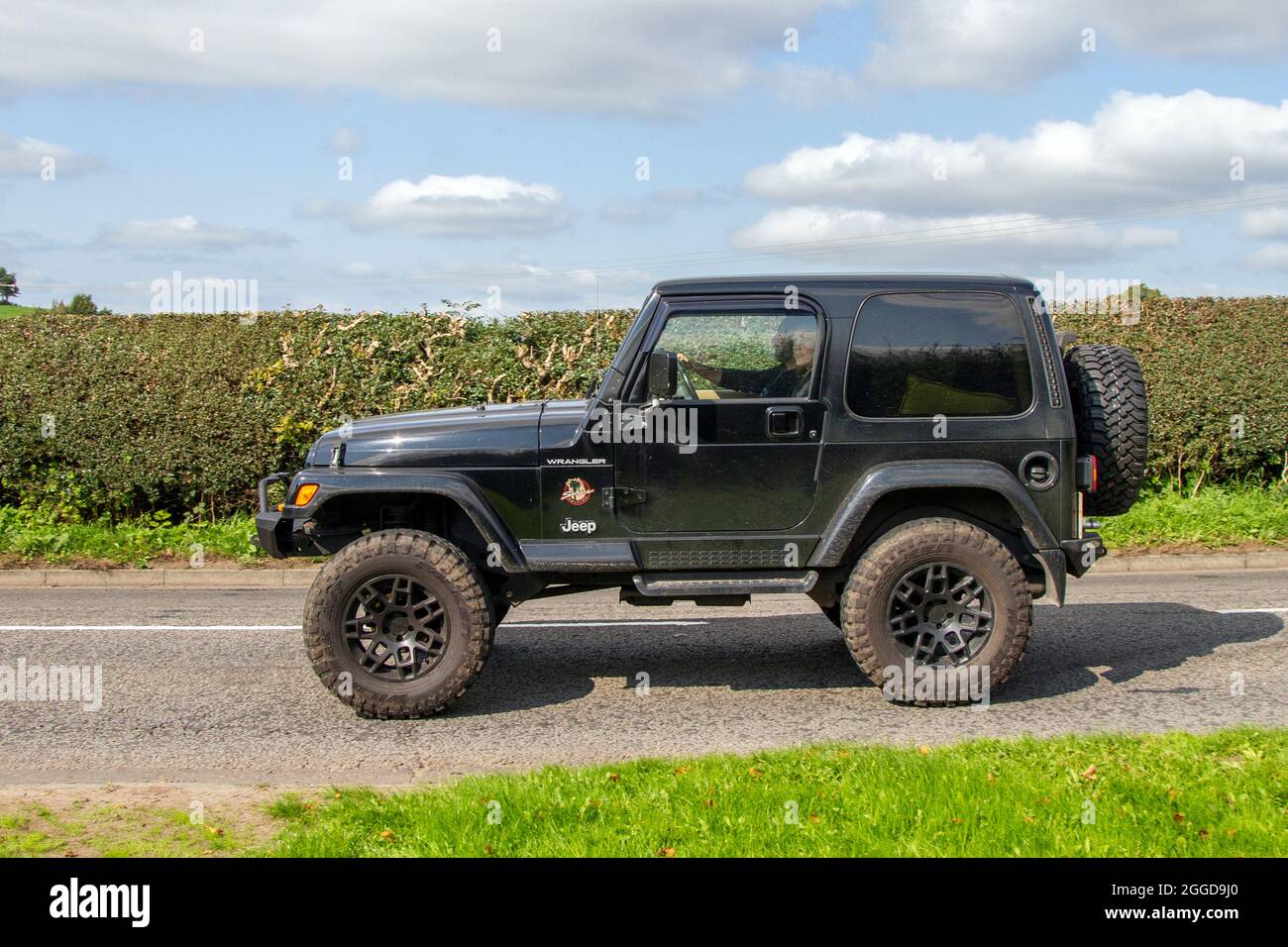 2002 black Jeep Wrangler, 2dr 4x4 off-road vehicle en-route to Capesthorne  Hall classic August car show, Cheshire, UK Stock Photo - Alamy