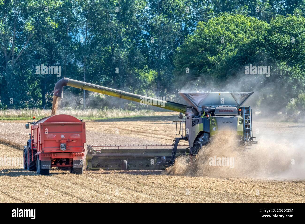 Claas Lexion 8900 combine harvester working and offloading grain to a