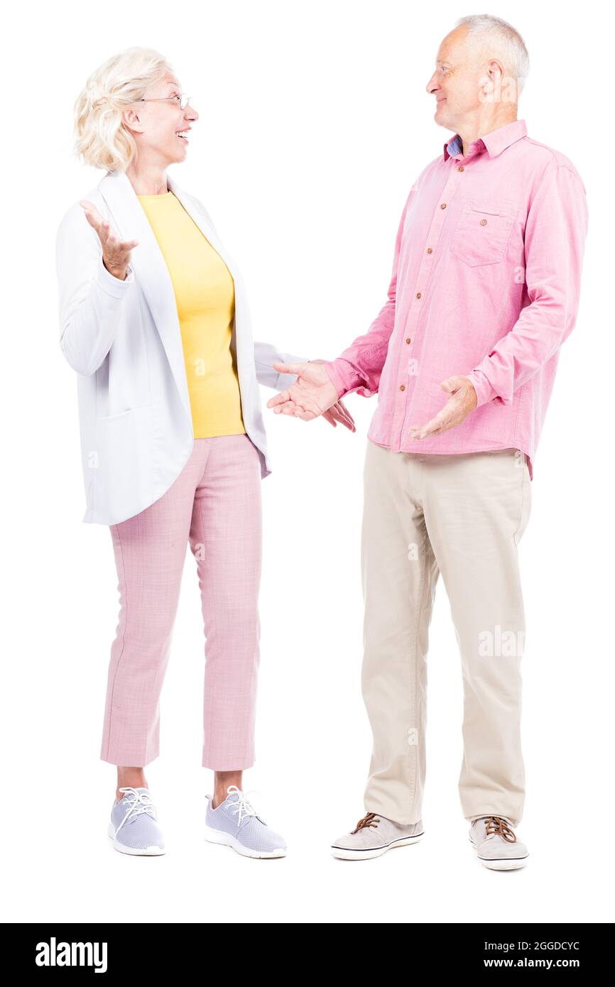 Vertical full length shot of senior Caucasian man and woman wearing casual clothes feeling surprised with good news Stock Photo