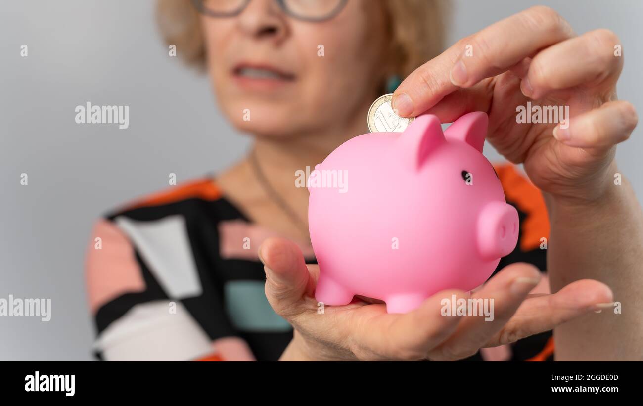 Elderly woman puts coin in hi-res stock photography and images - Alamy