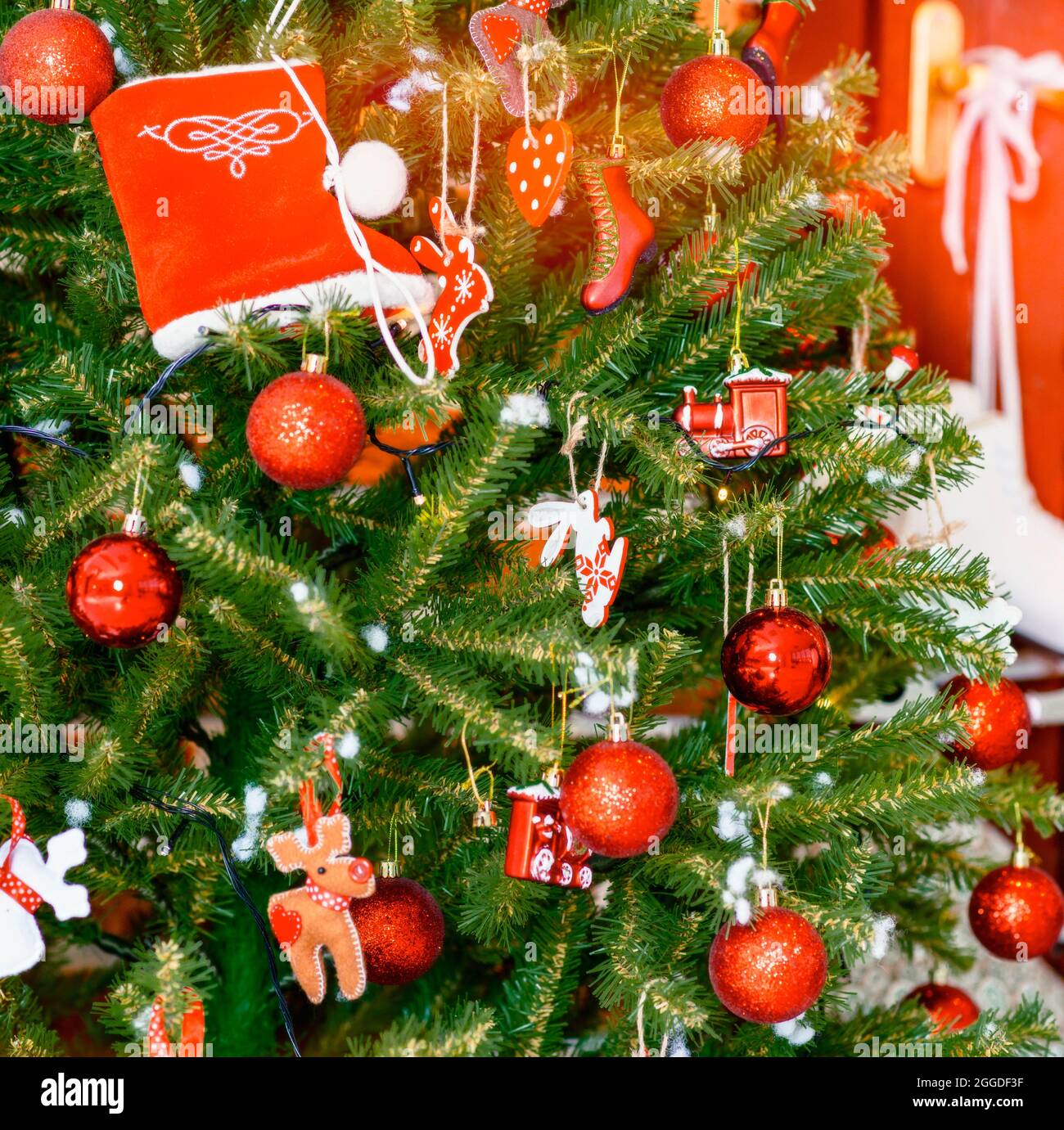 2022. Christmas Tree With Christmas Toys: Wooden Sleigh, Small Bird, Cones, Balls, Colored Lights.concept: New Year, Christmas, Greeting Card, Celebra Stock Photo - Alamy