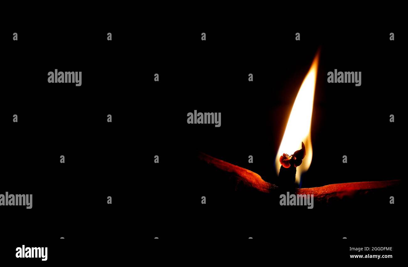 Fire Radiating Light Soil or clay lamp radiating light in dark. concept of removing darkness ...