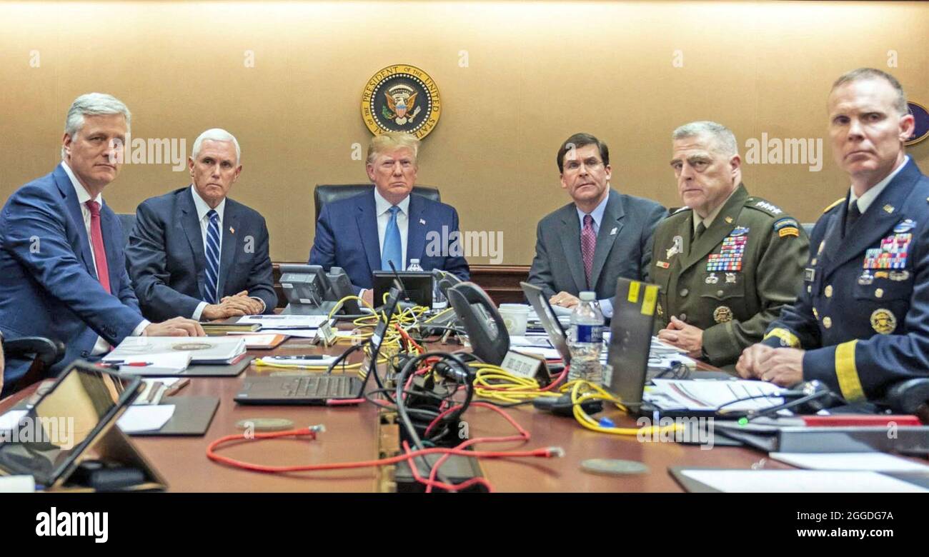 DONALD TRUMP as US President in the White House Situation Room in October 2019 during the operation to kill Islamic State leader Abu Bakr al-Baghdadi. From left: U.S. National Security Advisor Robert O'Brien, Vice President Mike Pence, Trump, Defence Secretary Mark Esper, Chairman Mark Milley, Brigadier General Marcus Evans. Photo: White House Official Stock Photo