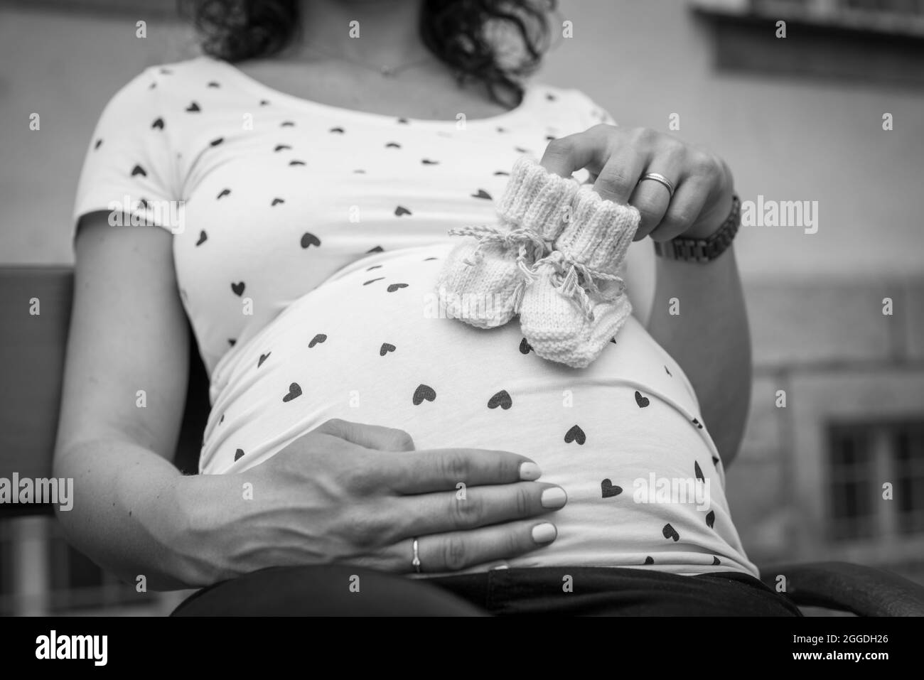 Creative baby bump photo shoot with pregnant mother and father Stock