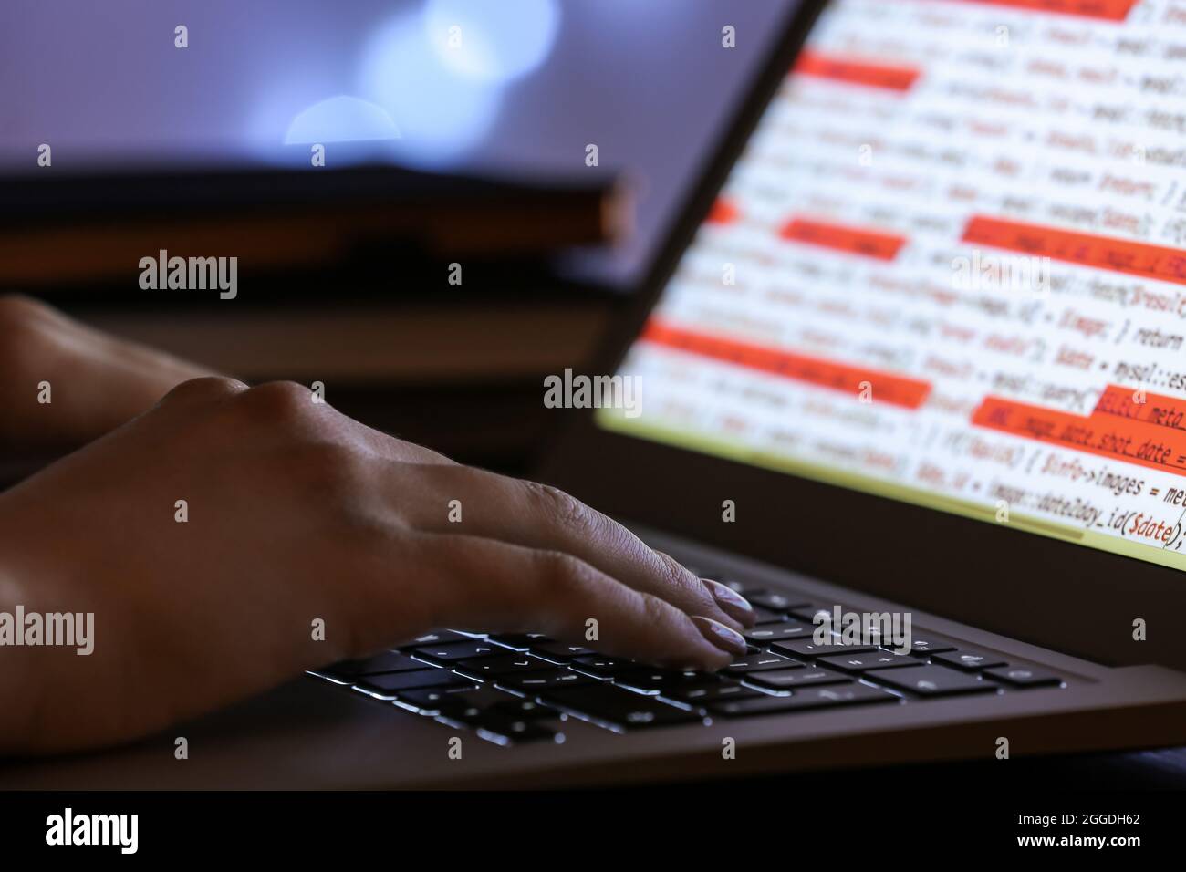 Female programmer working with laptop in office at night, closeup Stock ...