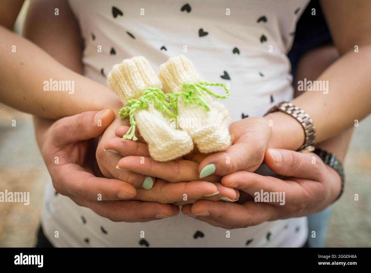 Creative baby bump photo shoot with pregnant mother and father Stock