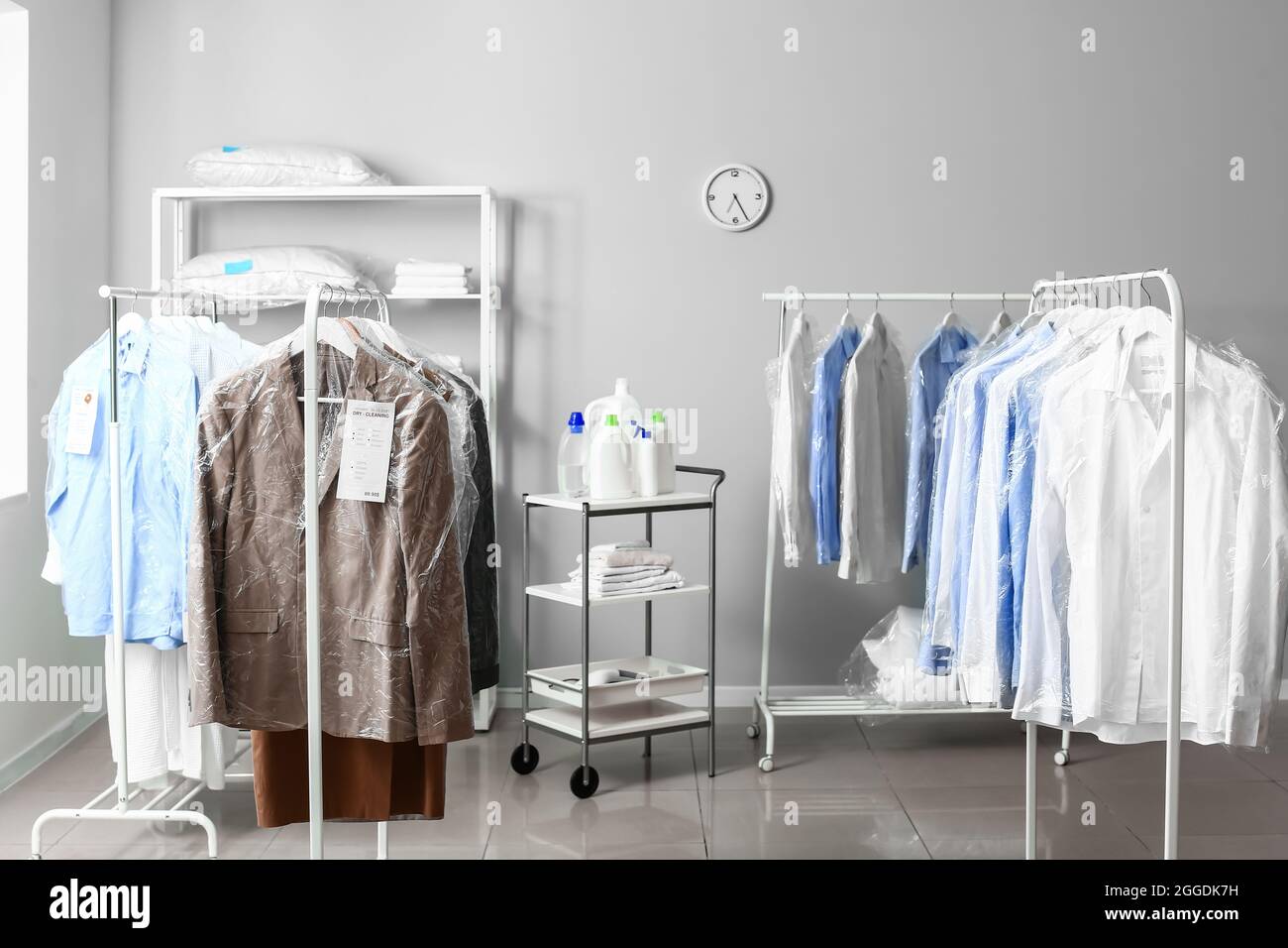Racks with clothes at modern drycleaner's Stock Photo Alamy