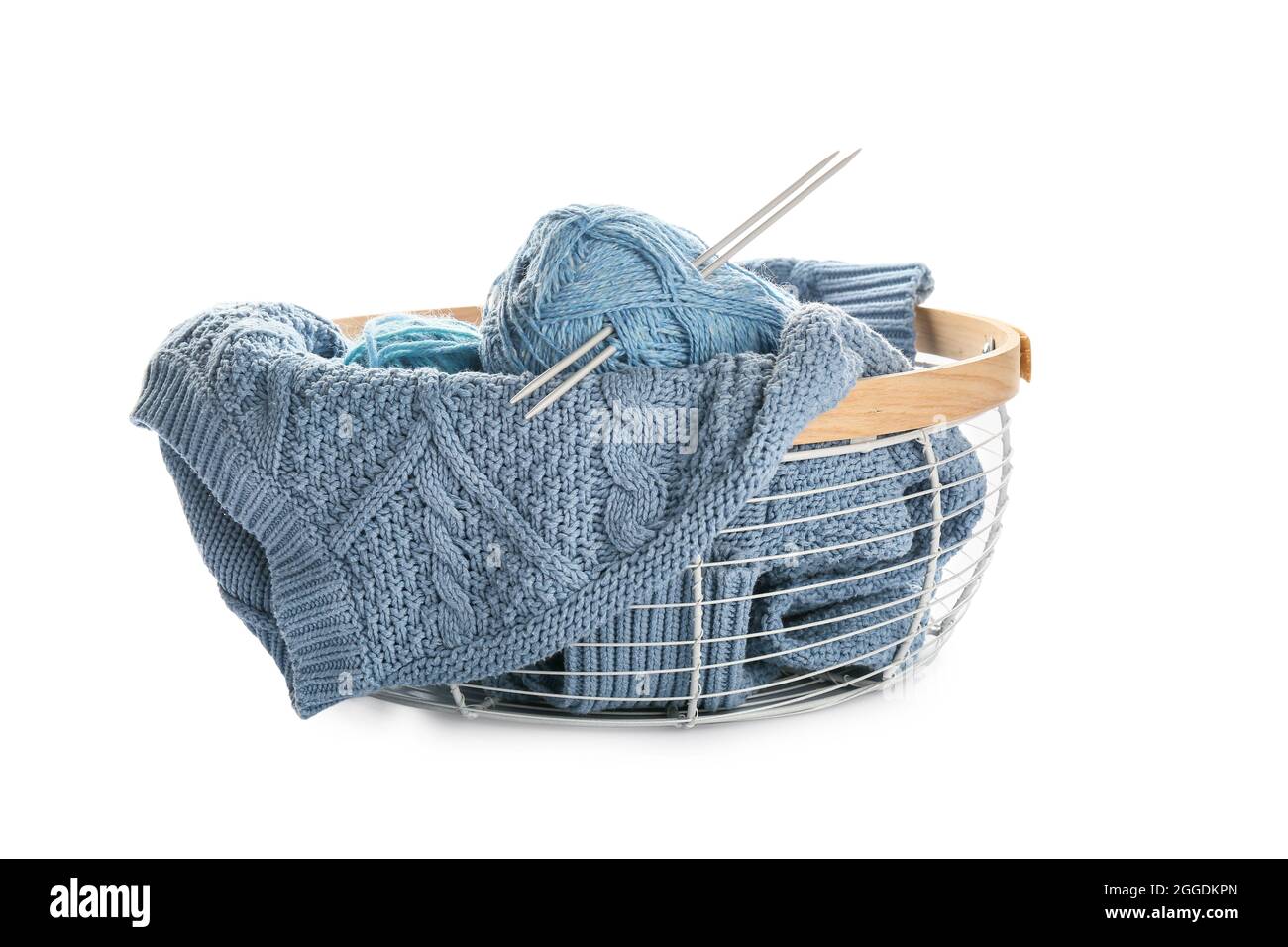 Basket with knitting yarn and sweater on white background Stock Photo ...
