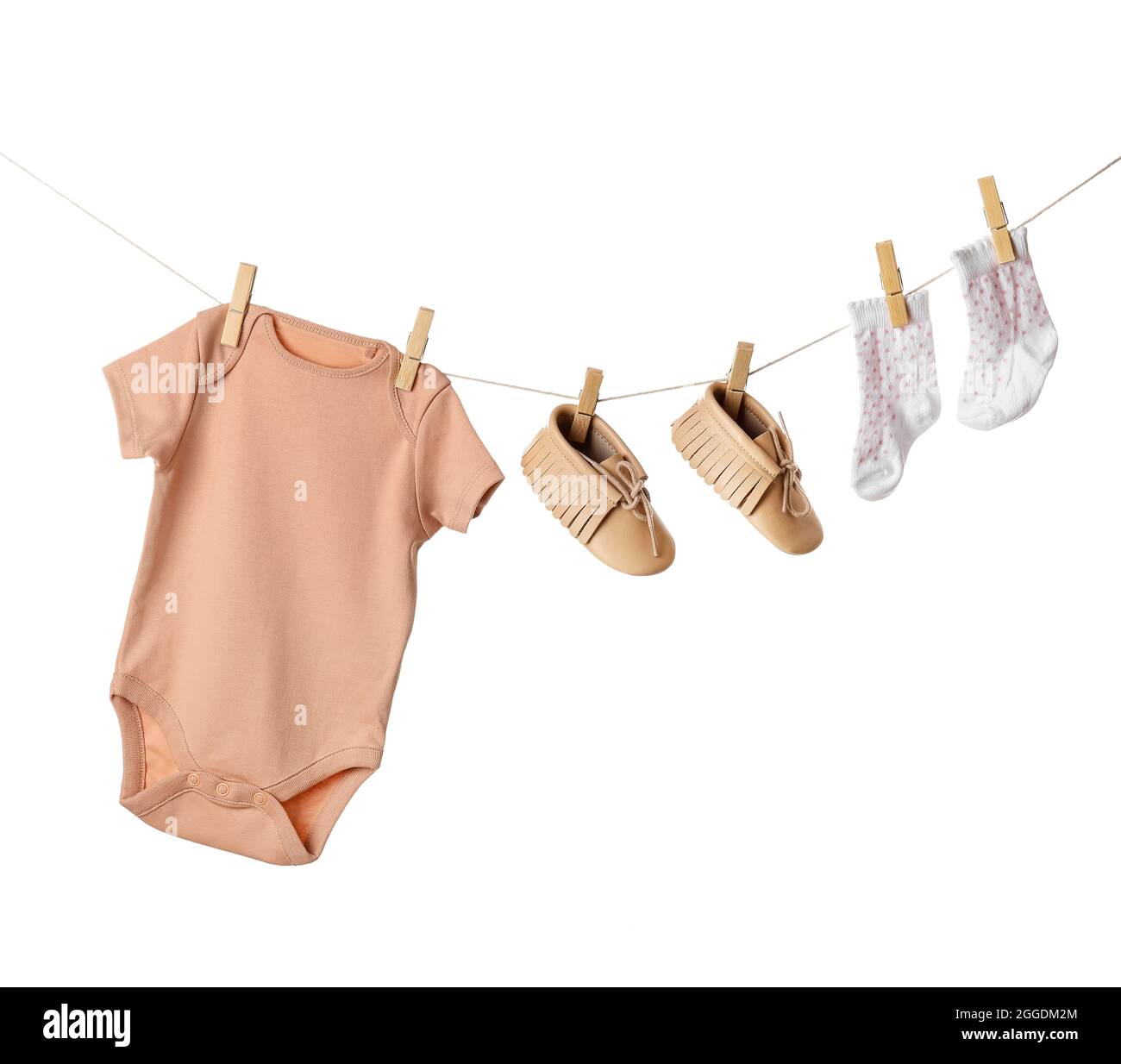 Baby clothes and shoes hanging on rope against white background Stock ...