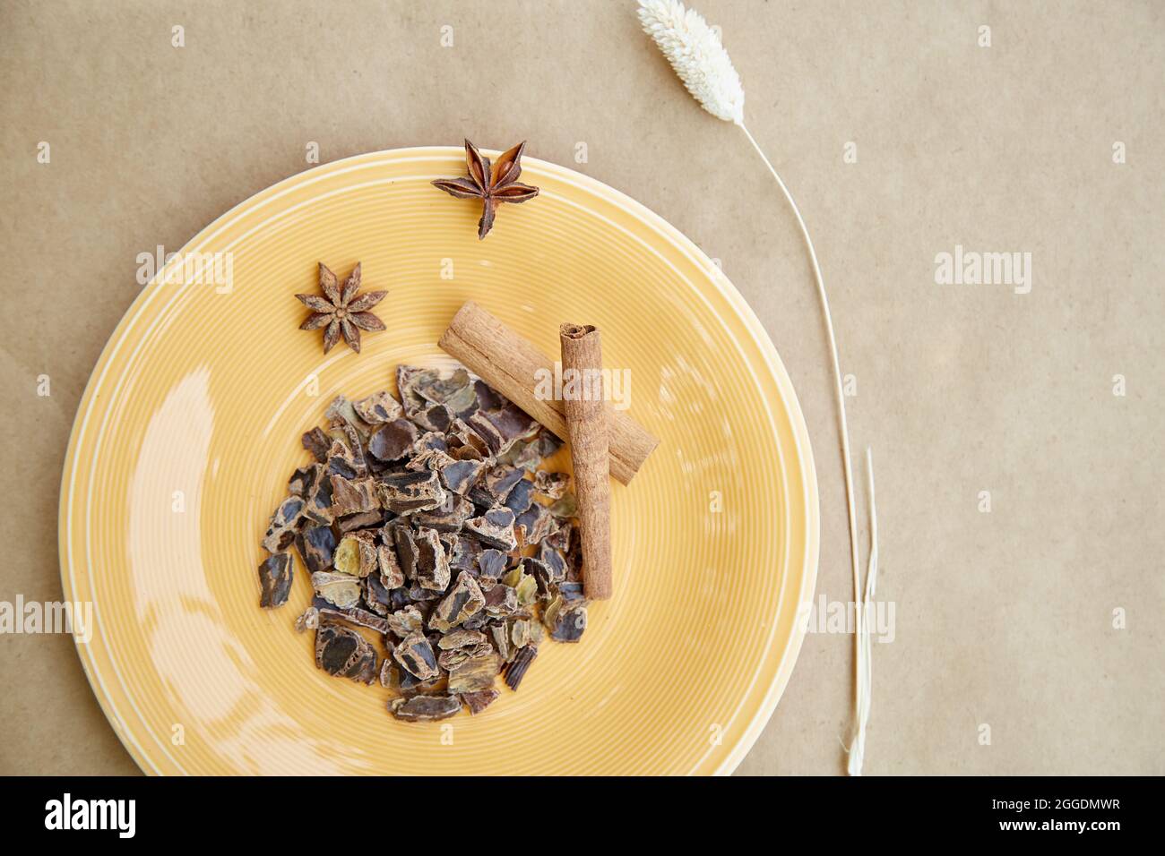 Plant-based alternative - natural carob. Organic antioxidants and protein. Decoration with cinnamon sticks and dried cloves. Top view. High quality ph Stock Photo