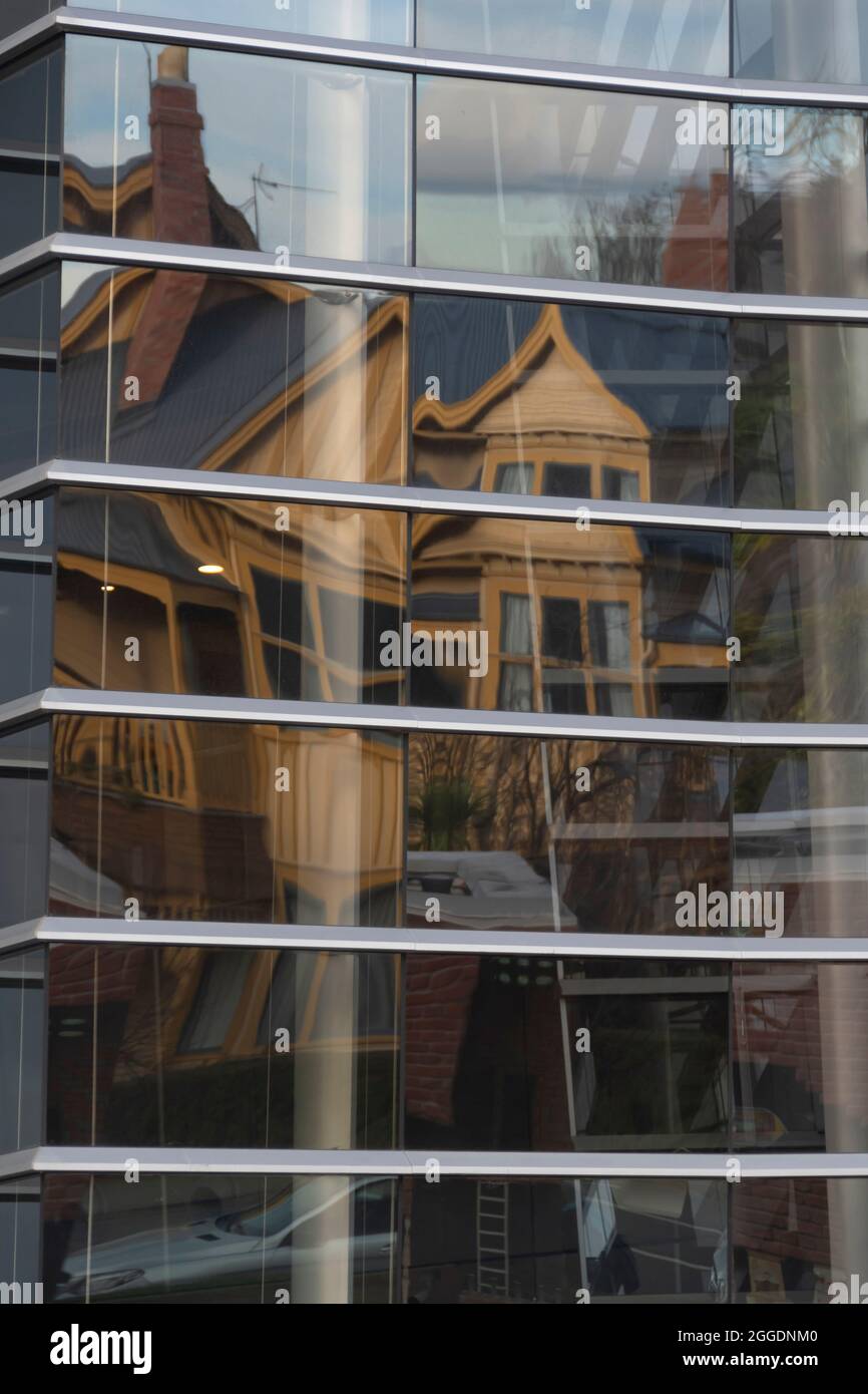 Reflections of old buildings on the glass facade of Christchurch Art