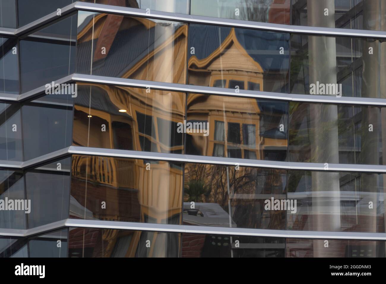 Reflections of old buildings on the glass facade of Christchurch Art
