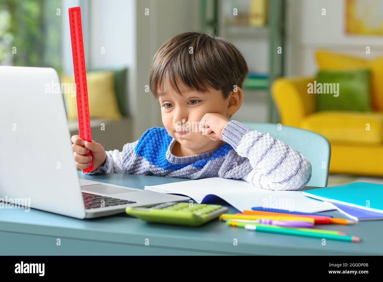 Little boy tired of studying online at home Stock Photo