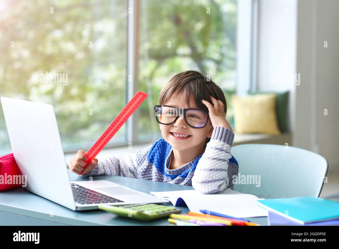 Little boy studying online at home Stock Photo