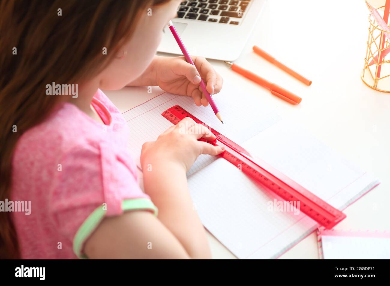 Little girl doing lessons at home Stock Photo