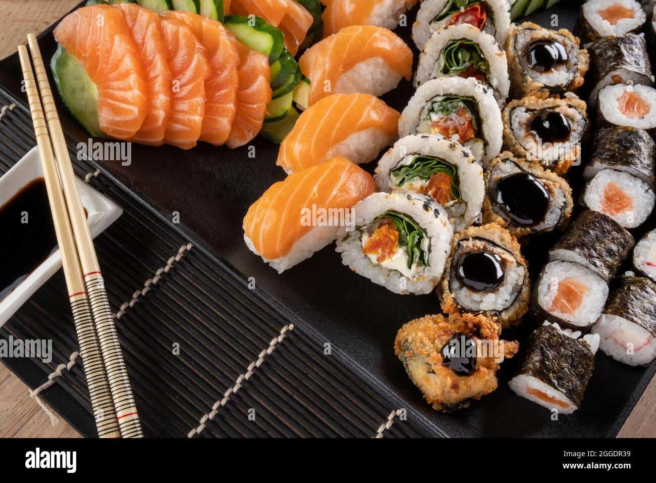 Mixed sushi roll and salmon sashimi. Stock Photo