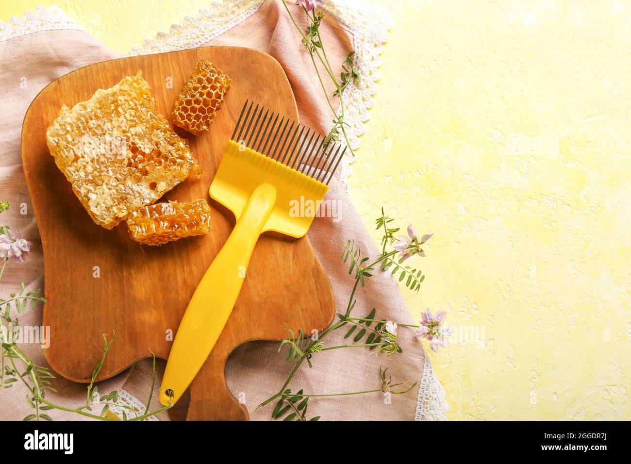 Bee hive uncapping comb and honey on color background Stock Photo