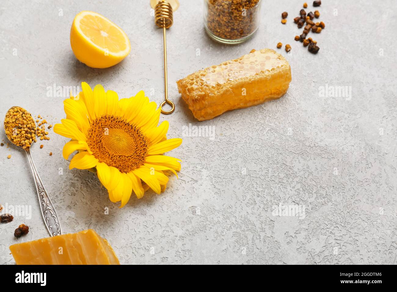 Different bee products with lemon on grunge background Stock Photo