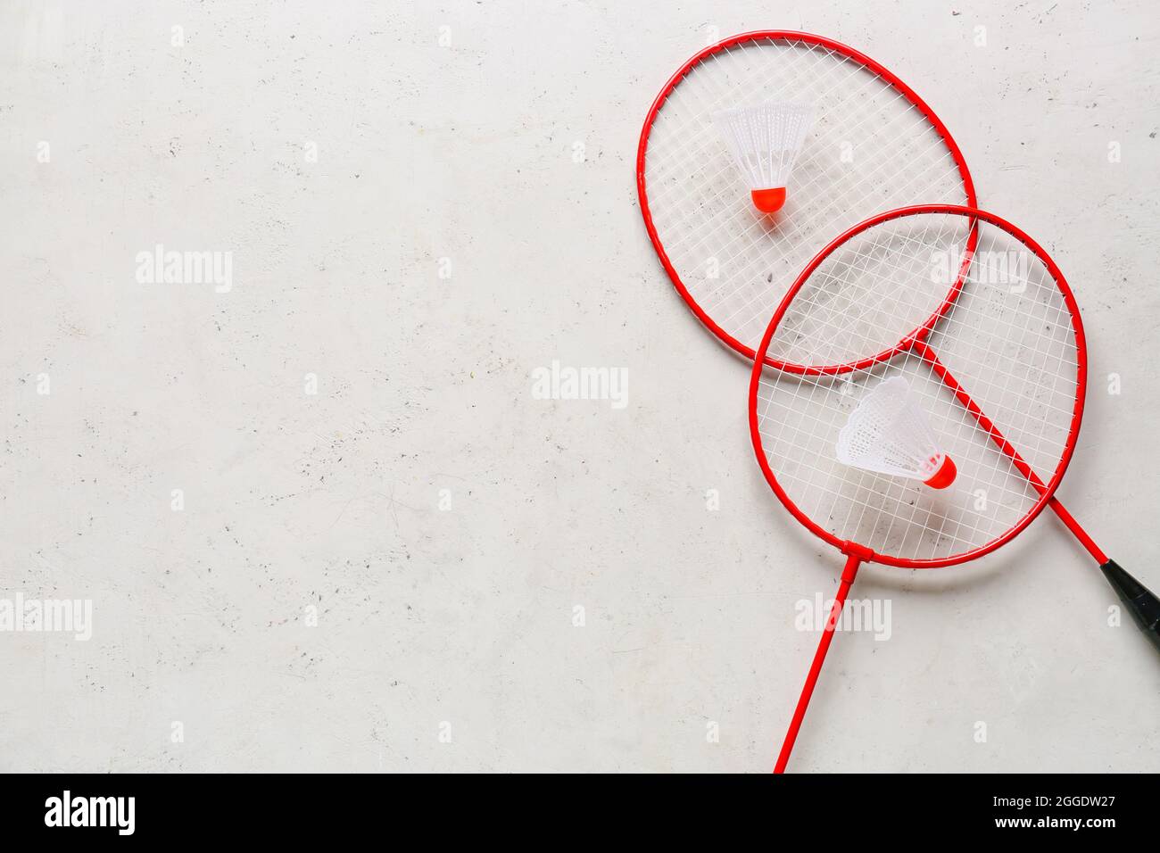 Badminton rackets and shuttlecocks on light background Stock Photo