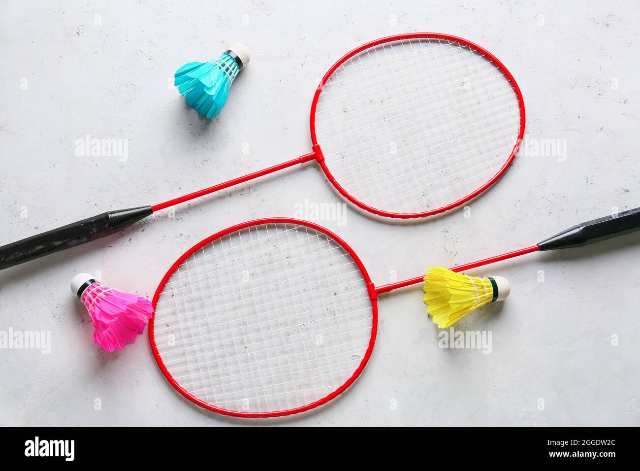 Badminton rackets and shuttlecocks on light background Stock Photo