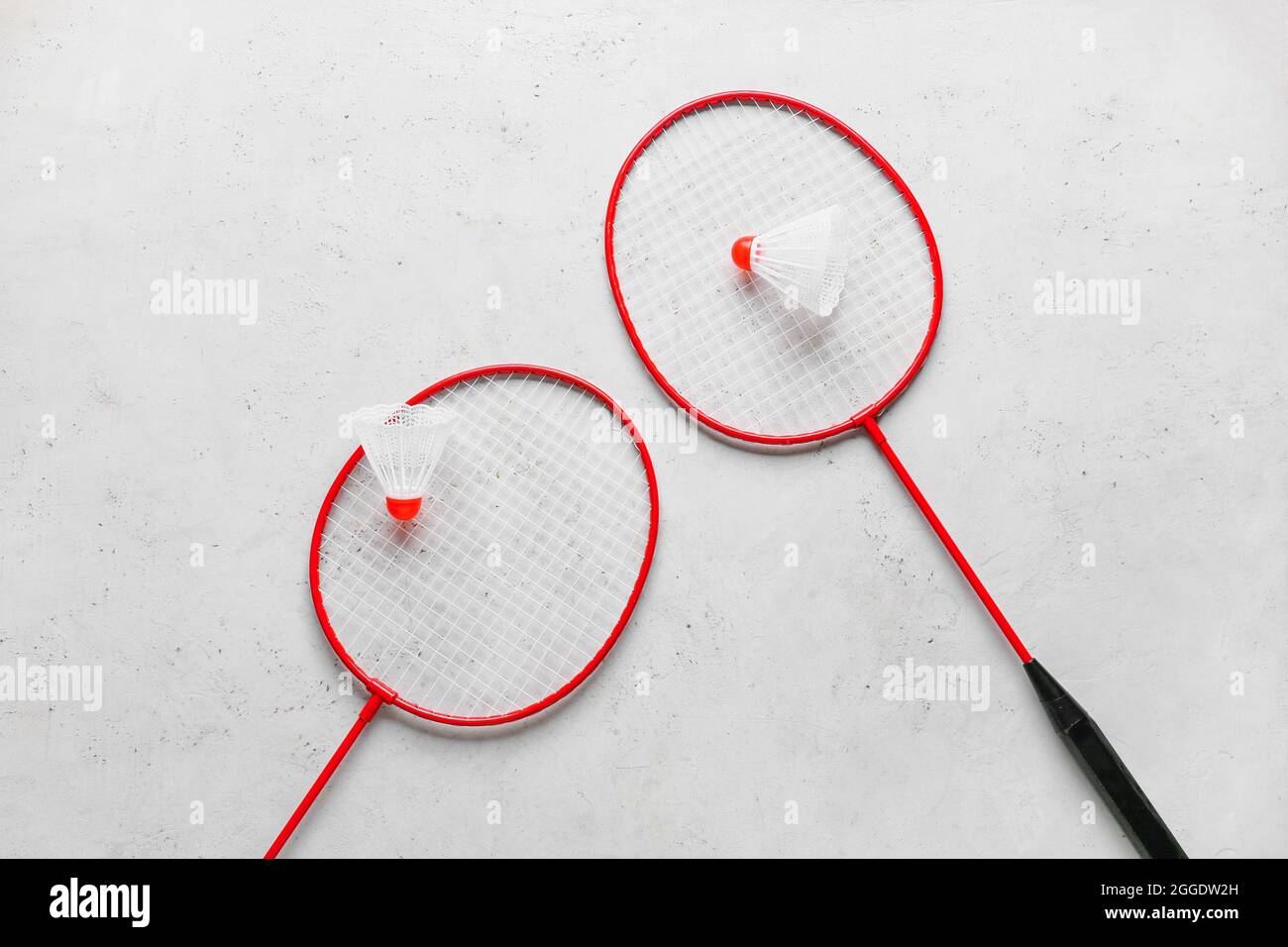 Badminton rackets and shuttlecocks on light background Stock Photo
