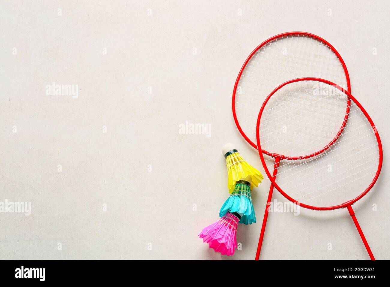 Badminton rackets and shuttlecocks on light background Stock Photo