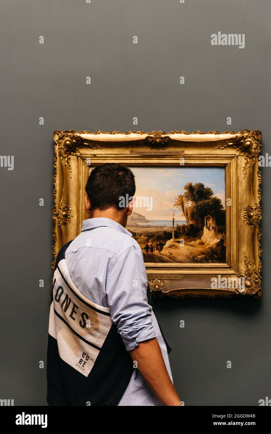 Hamburg, Germany - August 4, 2019: Teenager looking at painting in Hamburger Kunsthalle museum Stock Photo