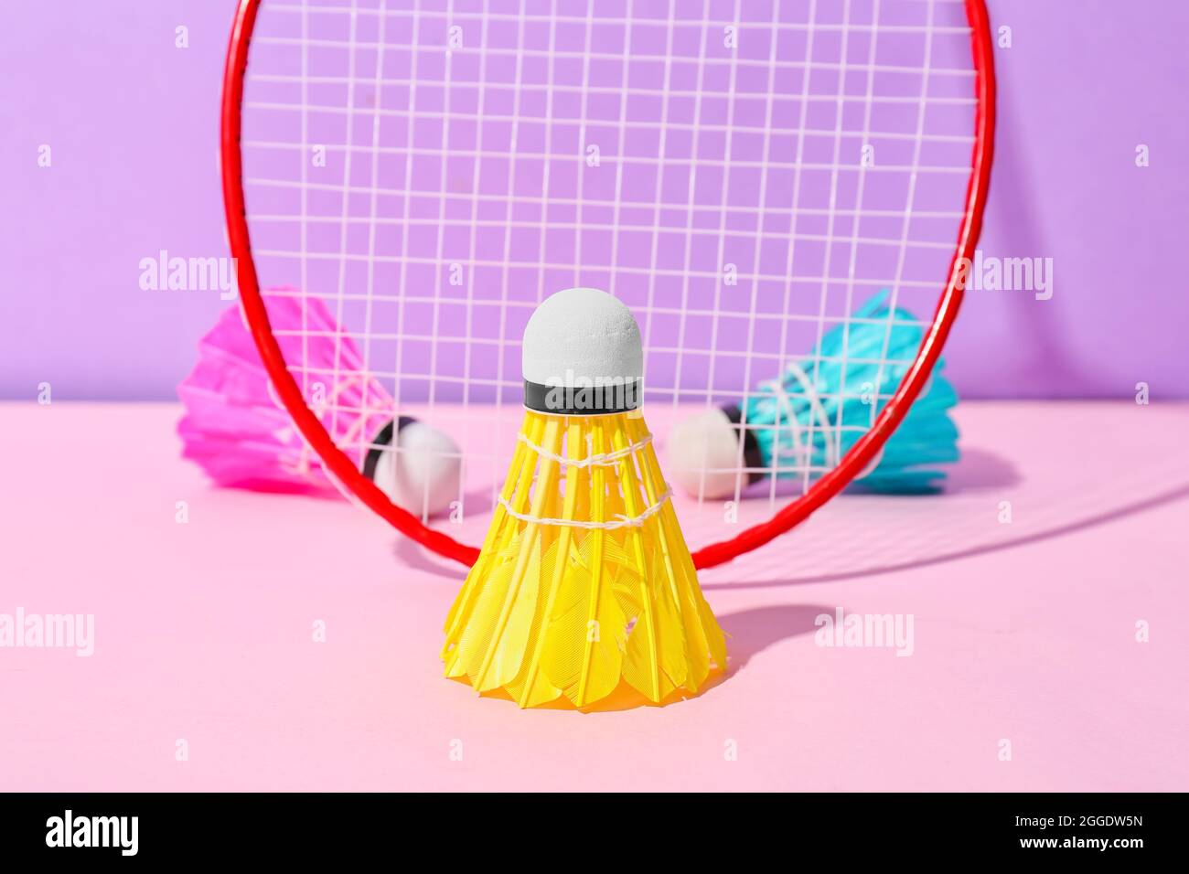 Badminton racket and shuttlecocks on color background Stock Photo