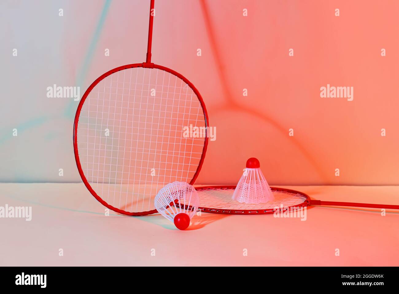 Badminton rackets and shuttlecocks on color background Stock Photo
