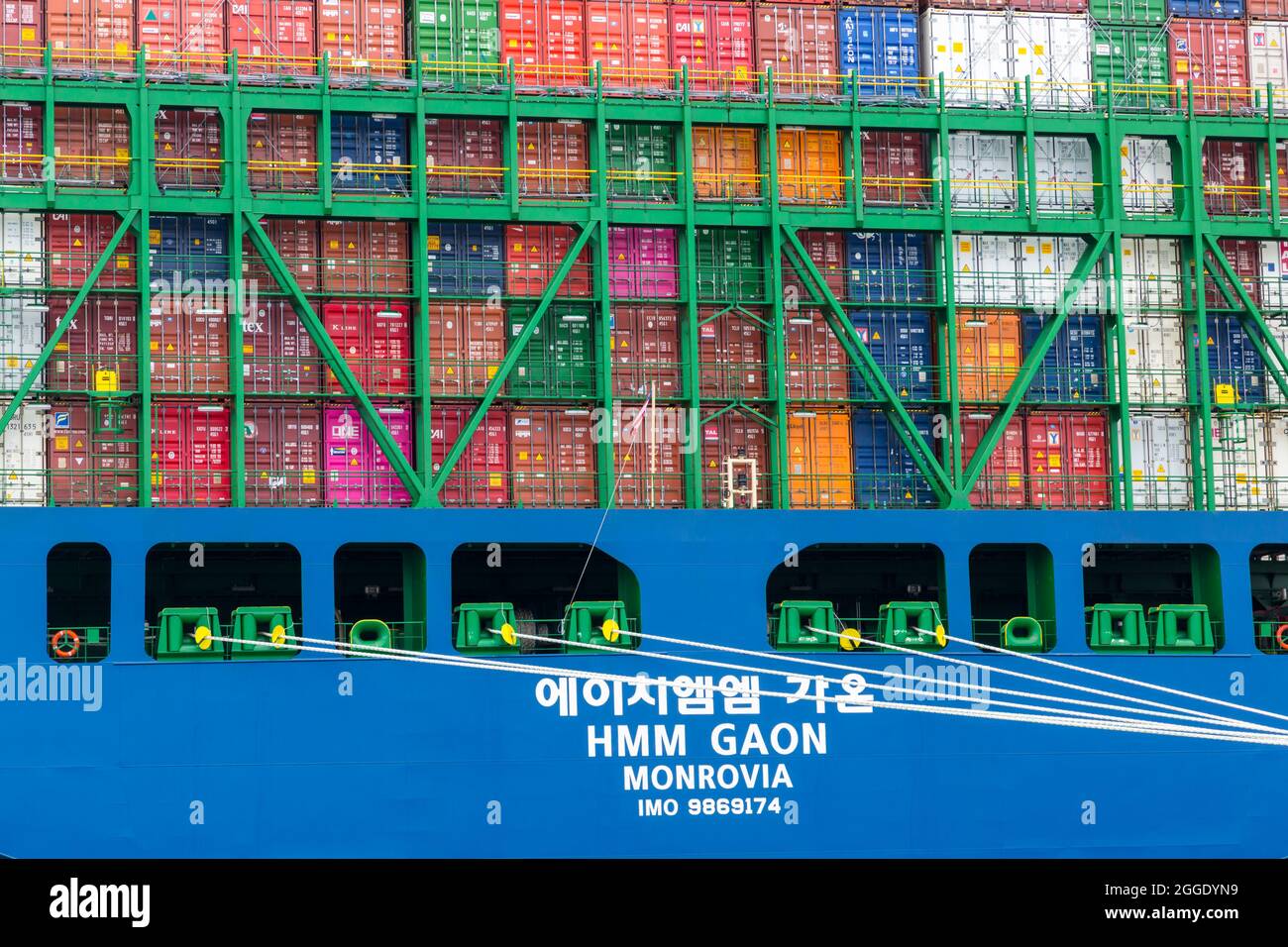 Cargo container crates loaded on HMM Gaon Monrovia moored at Southampton docks, Hampshire UK in August - shipping containers freight Stock Photo
