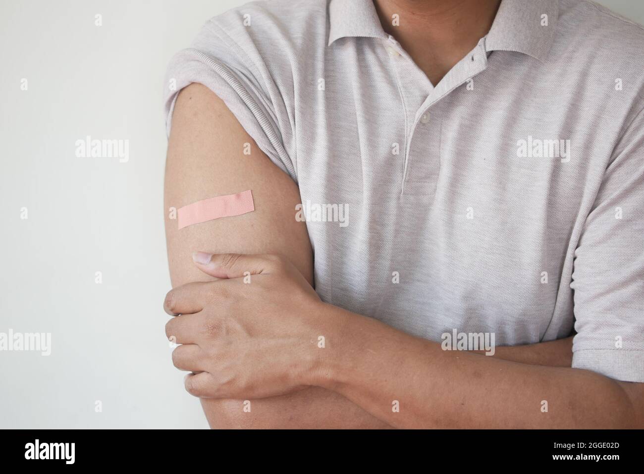 adhesive bandage on young man's arm with copy space  Stock Photo