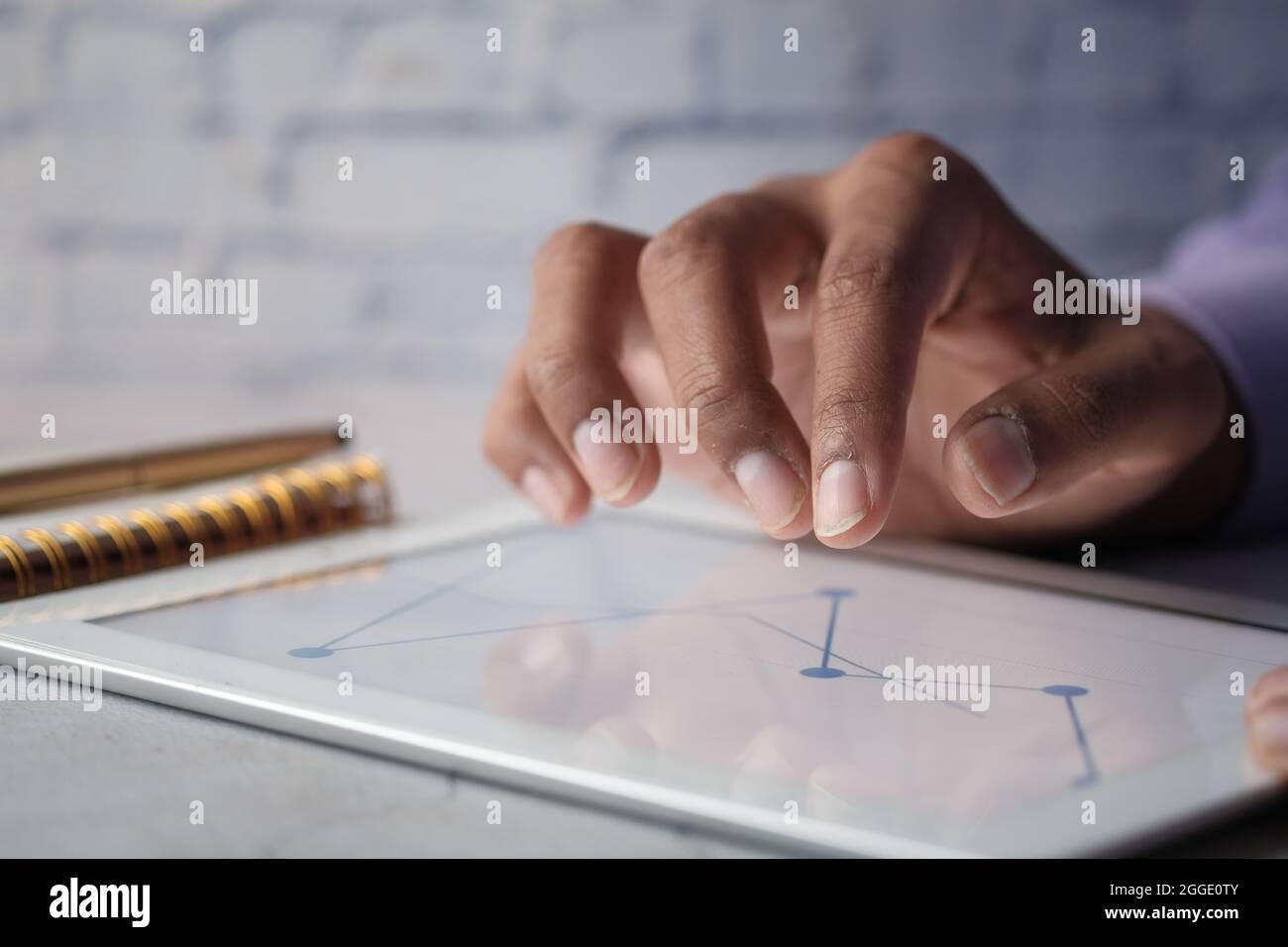man's hand working on digital tablet at office desk, using self created ...