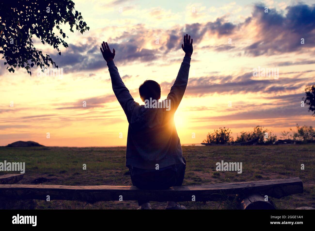 Happy Man Silhouette with Hands Up on the Sunset Background Stock Photo ...