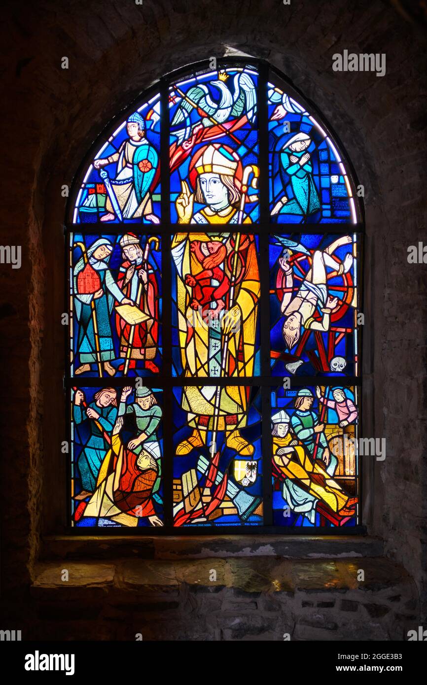Stained glass pointed arch window with scenes of St. Aegidius' murder, Klusenkapelle St. Aegidius, Bredeney, Essen, North Rhine-Westphalia, Germany Stock Photo