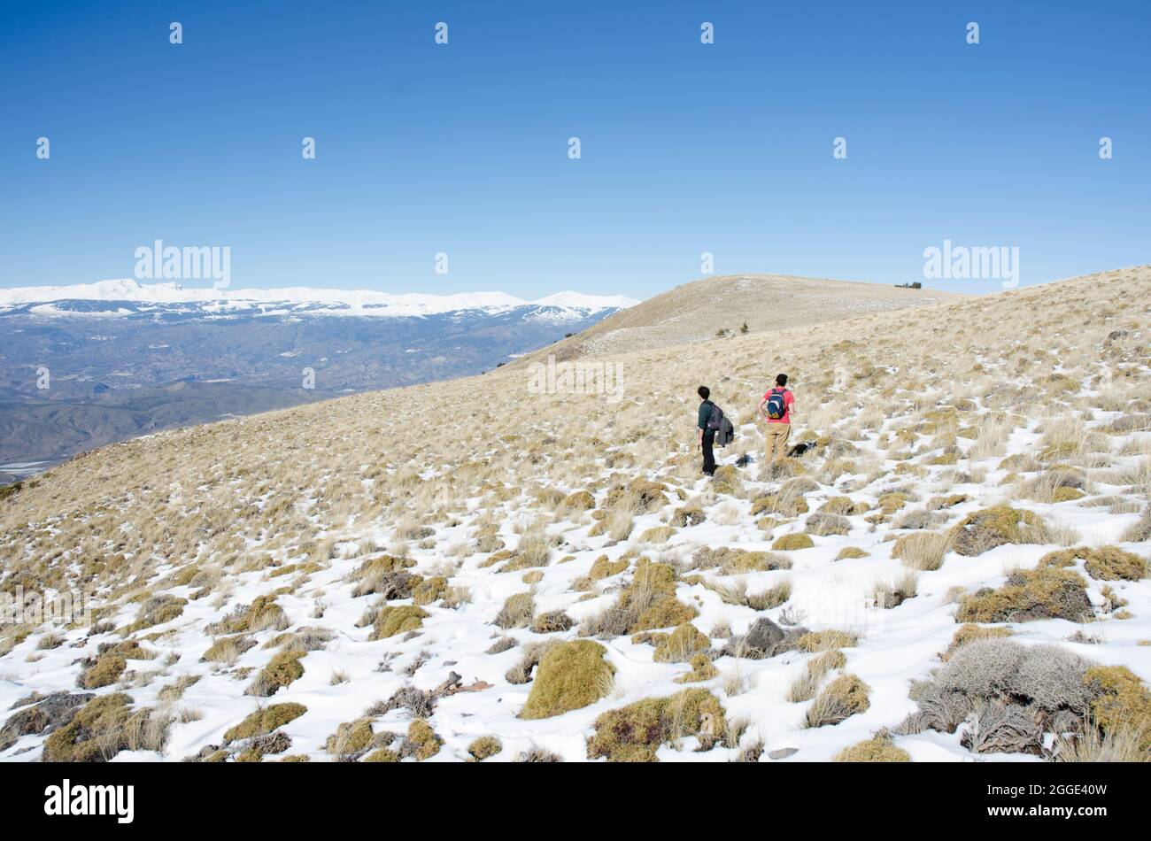 two men in the snowy mountains Stock Photo