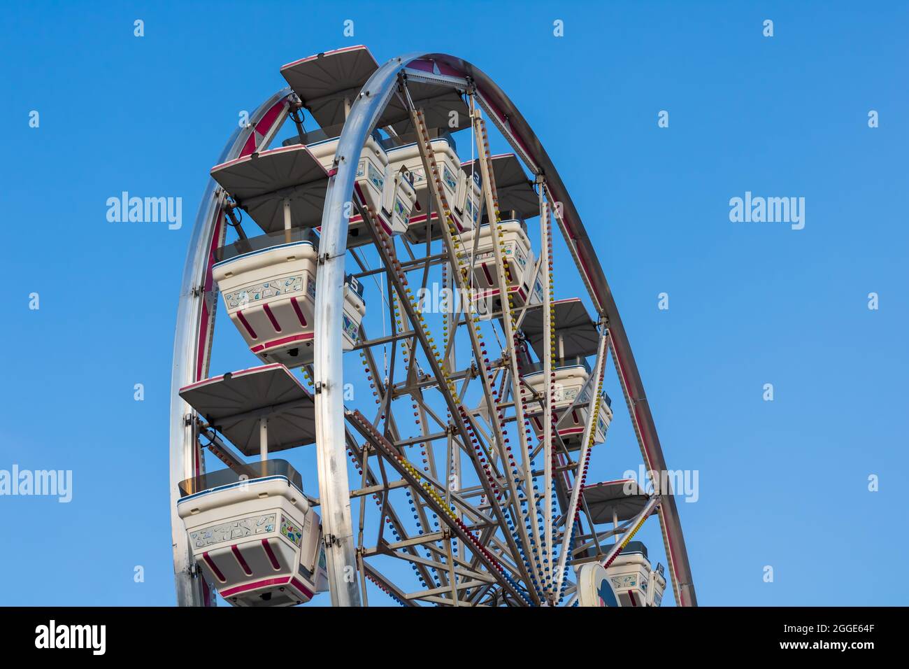 St. Thomas, Ontario, Canada - July 23 2021: Closeup of Conklin Group ferris wheel against blue sky. Stock Photo